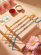 NVR Set of 4 Multicolor Artificial Beads Thread Rakhi with Roli Chawal Chandan Mishri | Grocsy