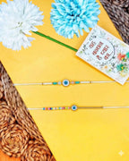 NVR Set of 2 Blue Evil Eye Thread Rakhi with Roli Chawal Chandan Mishri | Grocsy