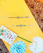 NVR Set of 2 Blue Evil Eye Thread Rakhi with Roli Chawal Chandan Mishri | Grocsy