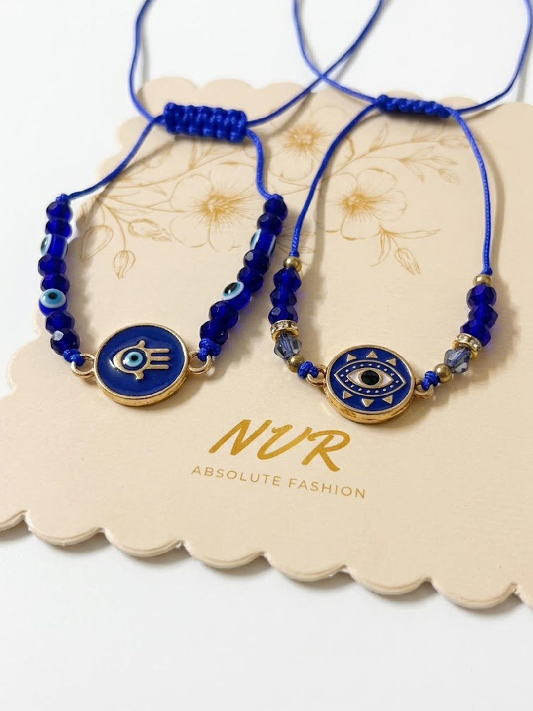 NVR Set of 2 Blue Evil Eye Thread Rakhi With Roli Chawal Chandan Mishri | Grocsy