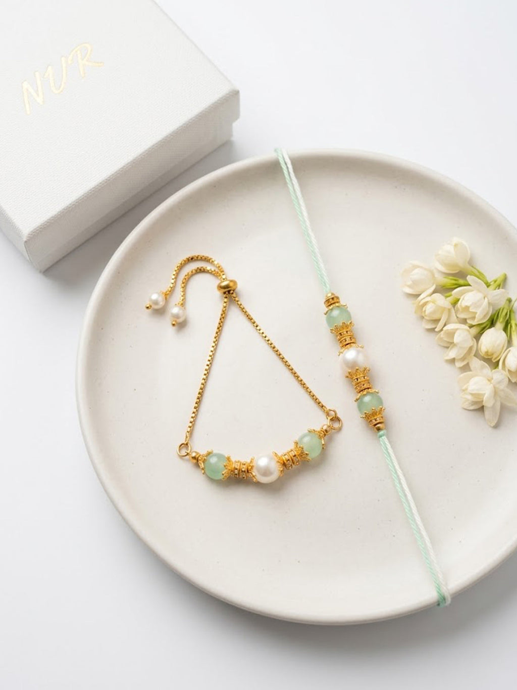 NVR Set of 2 Gold Toned Pearls & Artificial Beads Bhaiya Bhabhi Rakhi with Roli Chawal | Grocsy