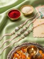NVR Set of 3 White Pearls Thread Rakhi with Roli Chawal Chandan Mishri | Grocsy