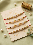 NVR Set of 4 White Pearls & Red Thread Rakhi With Roli Chawal Chandan Mishri | Grocsy