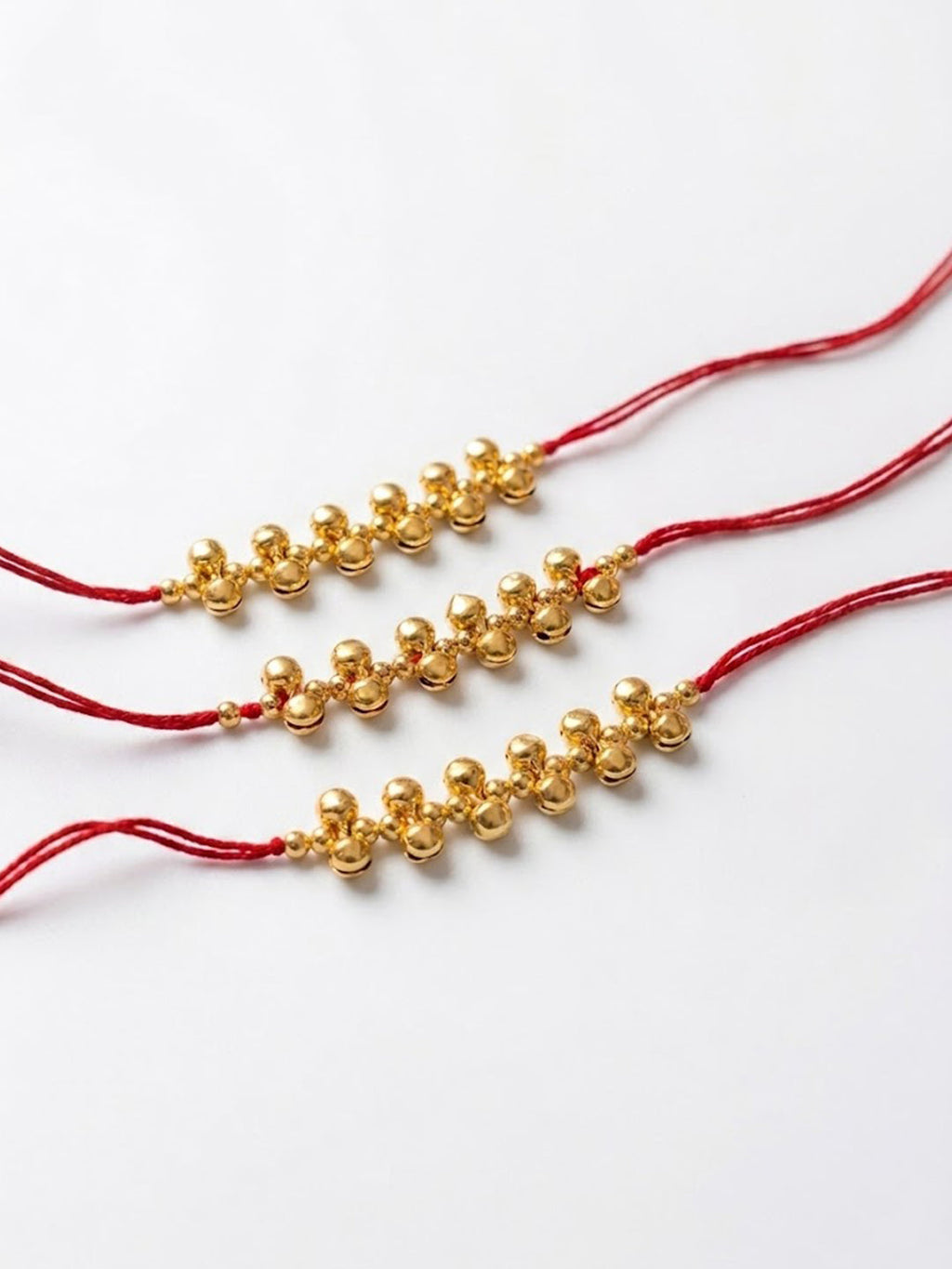 NVR Set of 3 Gold Toned Ghungroo & Red Thread Rakhi With Roli Chawal Chandan Mishri | Grocsy