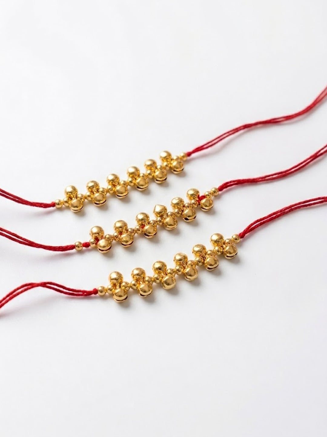 NVR Set of 3 Gold Toned Ghungroo & Red Thread Rakhi With Roli Chawal Chandan Mishri | Grocsy