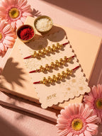NVR Set of 3 Gold Toned Ghungroo & Red Thread Rakhi With Roli Chawal Chandan Mishri | Grocsy