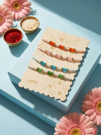 NVR Set of 4 White Pearls & Multicolor Thread Rakhi With Roli Chawal Chandan Mishri | Grocsy