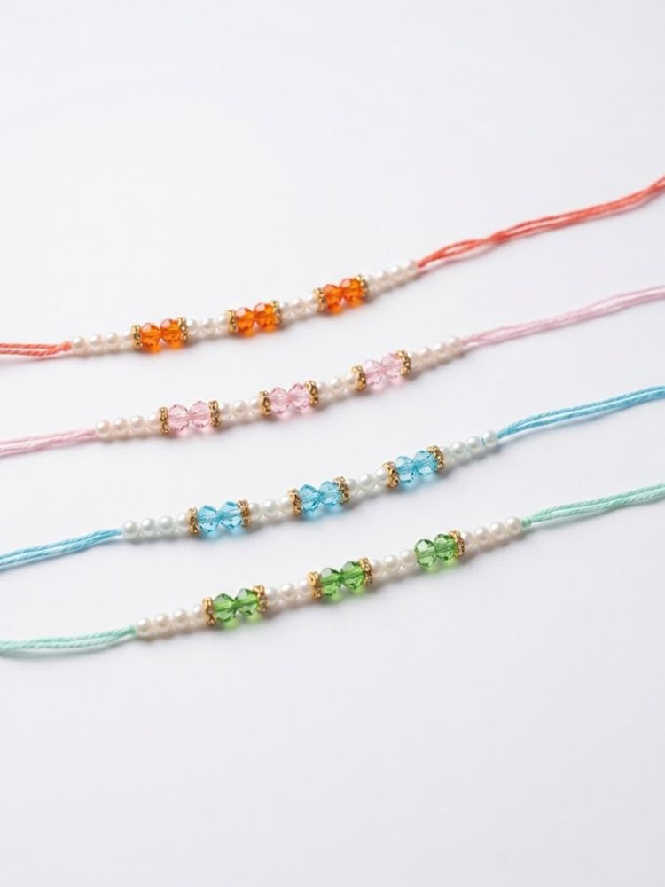 NVR Set of 4 White Pearls & Multicolor Thread Rakhi With Roli Chawal Chandan Mishri | Grocsy