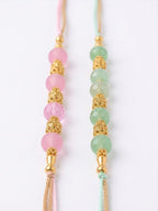 NVR Set of 2 Pink & Green Artificial Beads Thread Rakhi With Roli Chawal Chandan Mishri | Grocsy