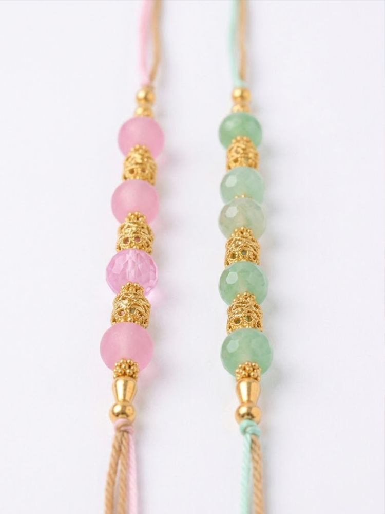 NVR Set of 2 Pink & Green Artificial Beads Thread Rakhi With Roli Chawal Chandan Mishri | Grocsy