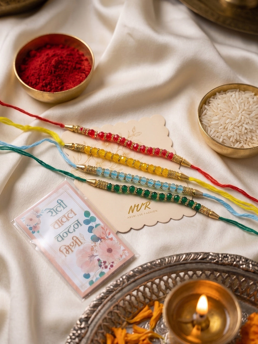 NVR Set of 4 Multicolor Artificial Beads Thread Rakhi with Roli Chawal Chandan Mishri | Grocsy