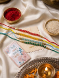 NVR Set of 4 Multicolor Artificial Beads Thread Rakhi with Roli Chawal Chandan Mishri | Grocsy