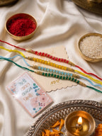 NVR Set of 4 Multicolor Artificial Beads Thread Rakhi with Roli Chawal Chandan Mishri | Grocsy