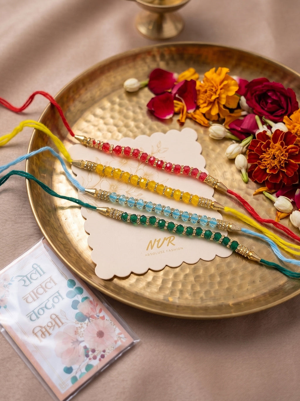 NVR Set of 4 Multicolor Artificial Beads Thread Rakhi with Roli Chawal Chandan Mishri | Grocsy