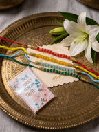 NVR Set of 4 Multicolor Artificial Beads Thread Rakhi with Roli Chawal Chandan Mishri | Grocsy
