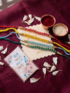 NVR Set of 4 Multicolor Artificial Beads Thread Rakhi with Roli Chawal Chandan Mishri | Grocsy