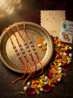 NVR Set of 4 Artificial Stones Floral Design Thread Rakhi with Roli Chawal Chandan Mishri | Grocsy