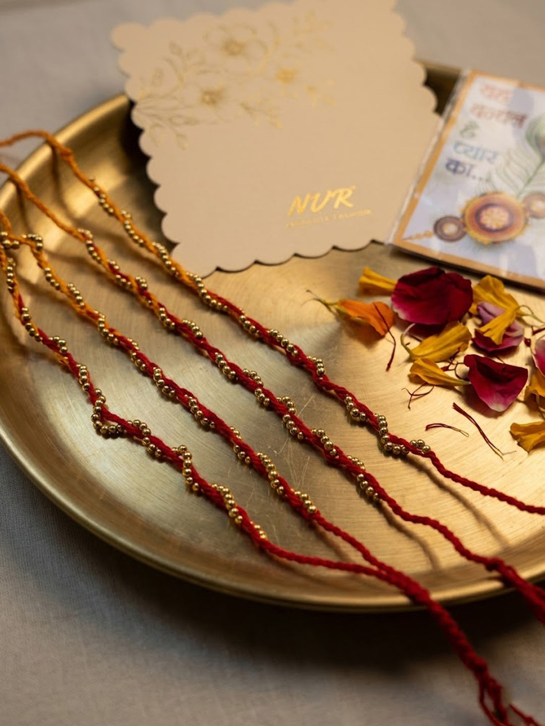 NVR Set of 4 Red & Yellow Thread Rakhi with Roli Chawal Chandan Mishri | Grocsy