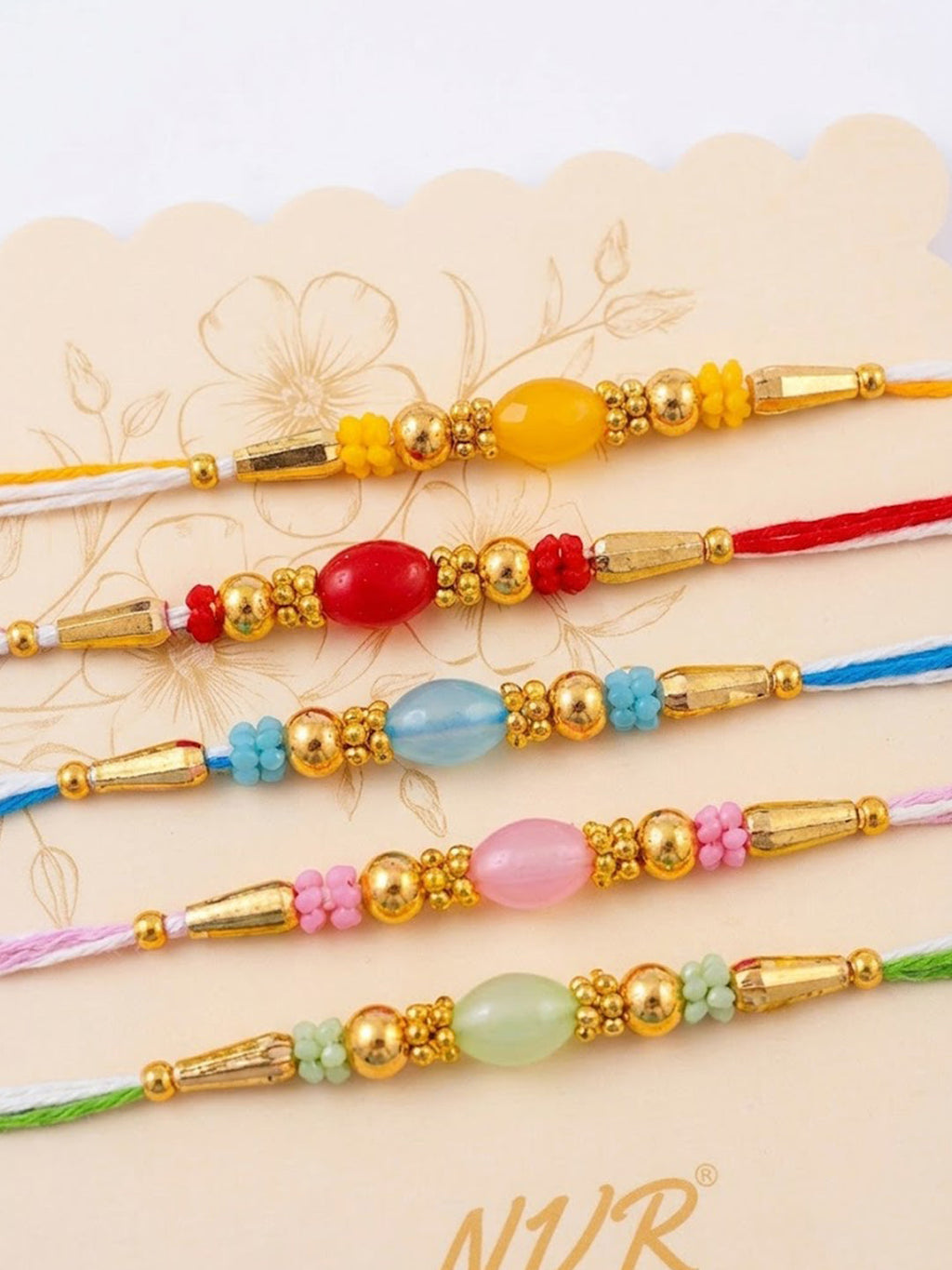NVR Set of 5 Multi Artificial Beads Thread Rakhi with Roli Chawal Chandan Mishri | Grocsy
