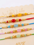 NVR Set of 5 Multi Artificial Beads Thread Rakhi with Roli Chawal Chandan Mishri | Grocsy