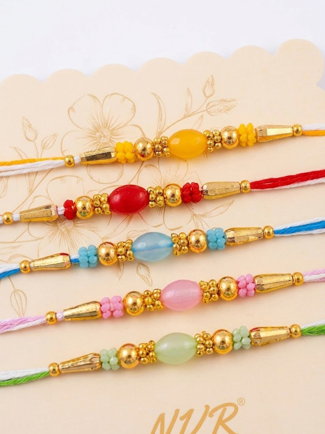 NVR Set of 5 Multi Artificial Beads Thread Rakhi with Roli Chawal Chandan Mishri | Grocsy