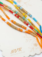 NVR Set of 6 Multi Artificial Beads Thread Rakhi with Roli Chawal Chandan Mishri | Grocsy