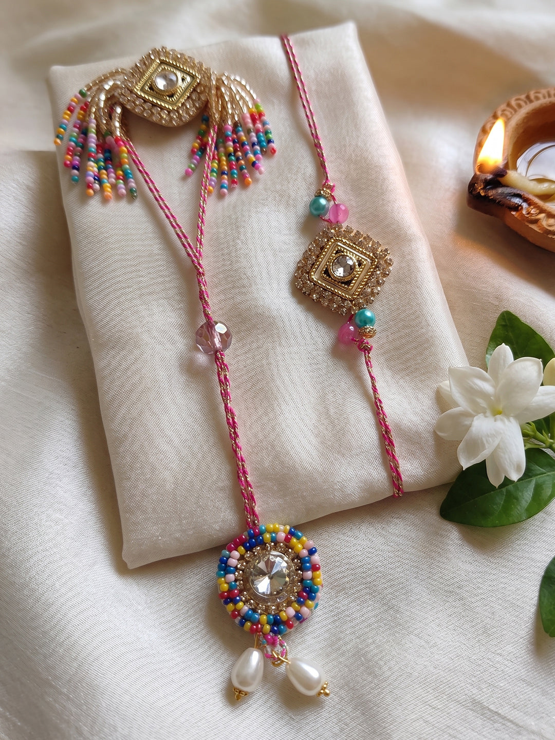 NVR Set of 2 White Artificial Stones Golden Toned Bhaiya Bhabhi Rakhi With Roli Chawal | Grocsy