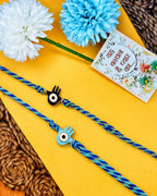 NVR Set of 2 Evil Eye & Blue Thread Rakhi with Roli Chawal Chandan Mishri | Grocsy