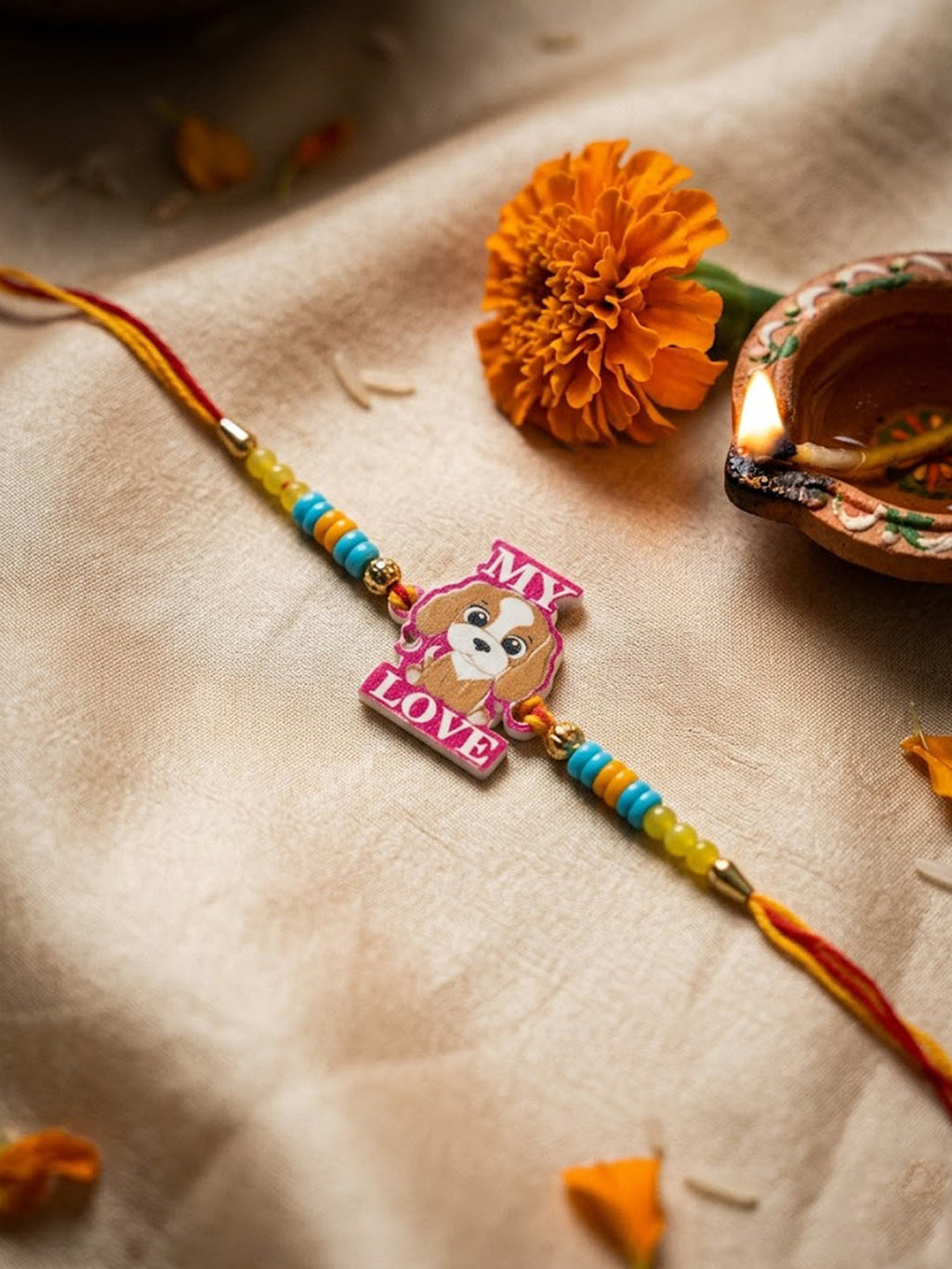 NVR Stylish Artificial Beads Kids Thread Rakhi with Roli Chawal Chandan Mishri | Grocsy