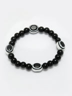 NVR Women & Men Black Evil Eye Elasticated Rakhi With Roli Chawal | Grocsy