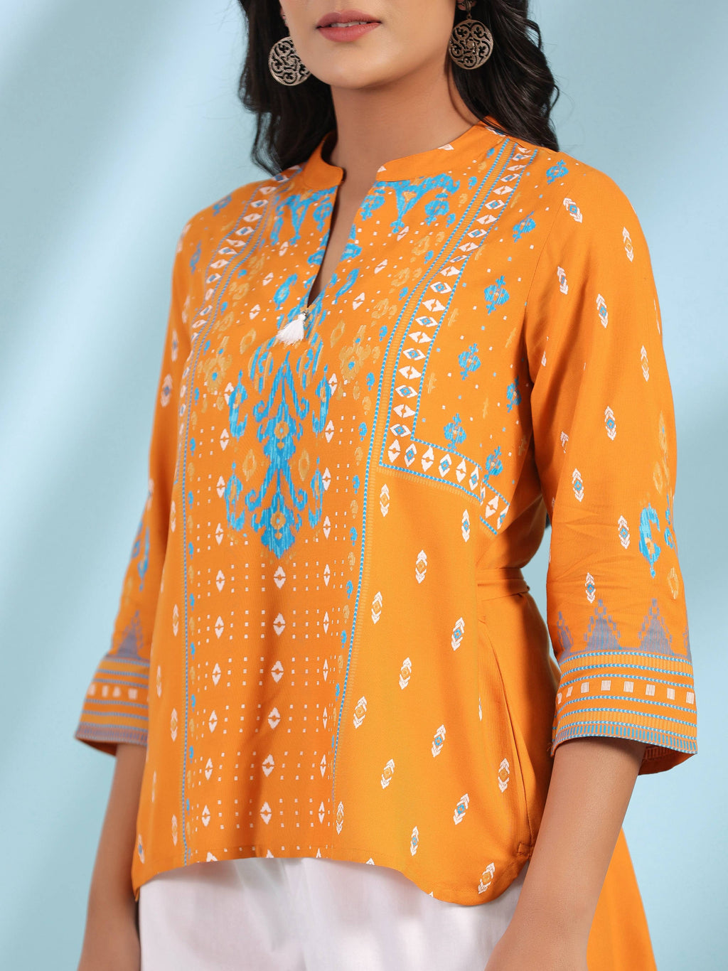 Juniper Mustard Rayon Ikat Placement Printed High-Low Tunic With Side Slits & Tassels | Grocsy
