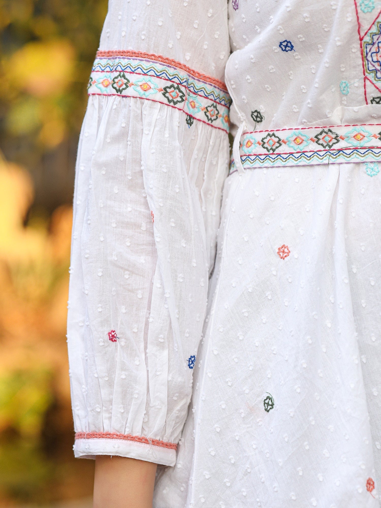 Juniper White Cotton Dobby Peplum Tunic With Multi Colored Thread Embroidery | Grocsy