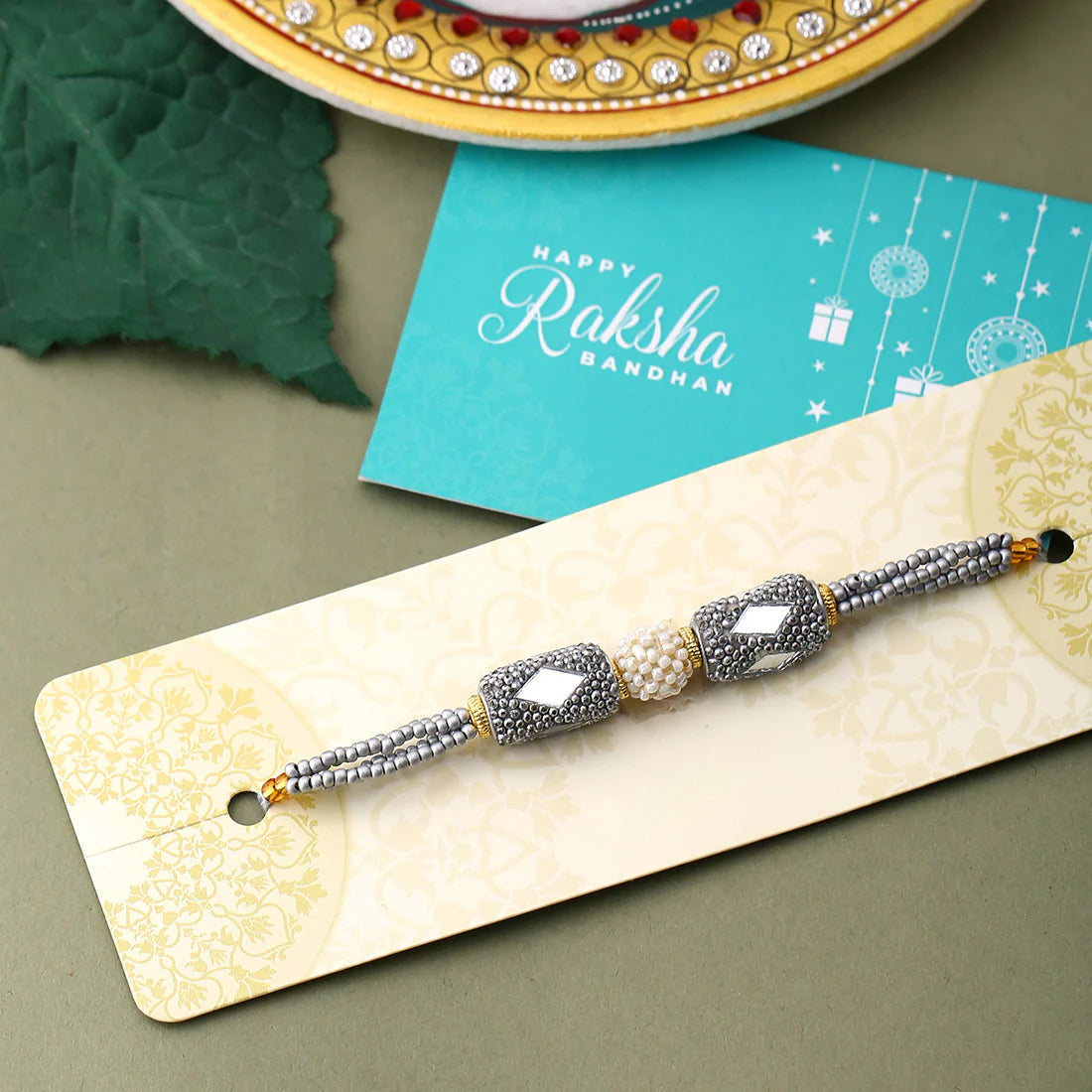 trueBrowns X Voylla Silver Beaded Rakhi With Roli Chaawal Pack | Grocsy