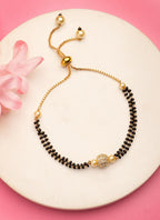 NVR Women Gold-Polished & Black Brass AD-Studded Hand Mangalsutra Bracelet | Grocsy