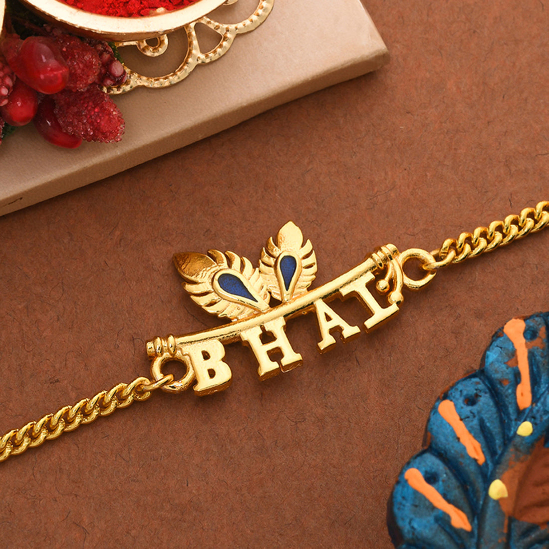 trueBrowns Peacock Feather Motif Gold Tone Bhai Rakhi | Grocsy