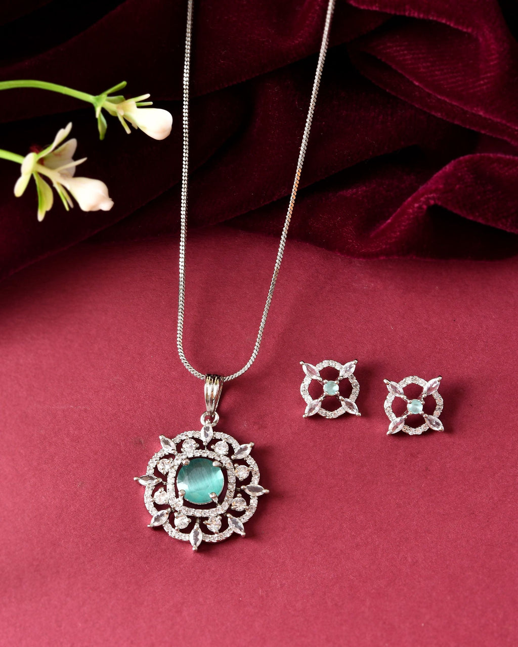 VOJ Silver Plated Sea Green Circulare Stone Studded Sun Shaped Ad Pendant With Chain Set | Grocsy