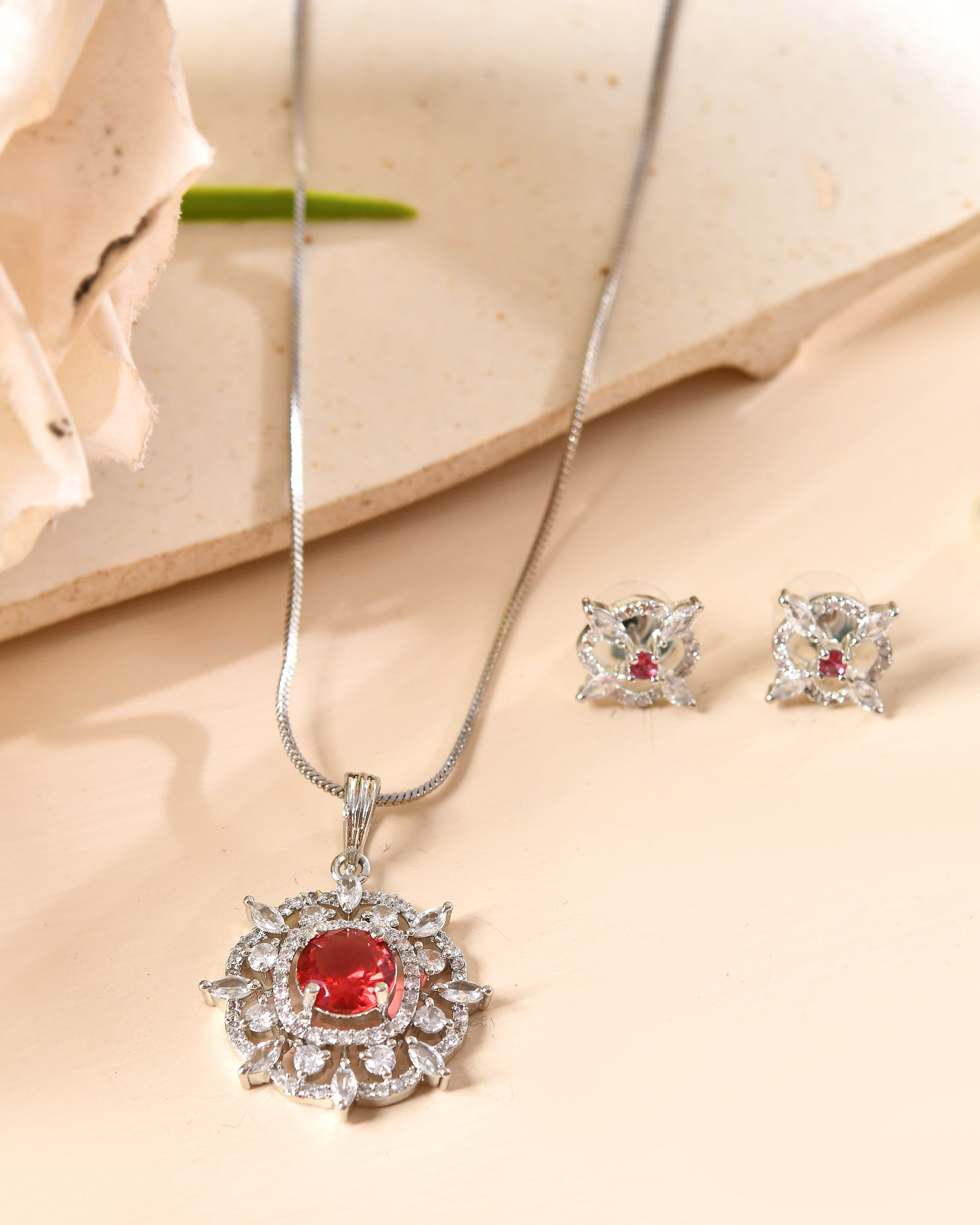 VOJ Silver Plated Ruby Red Circular Stone Studded Sun Shaped Ad Pendant With Chain Set | Grocsy