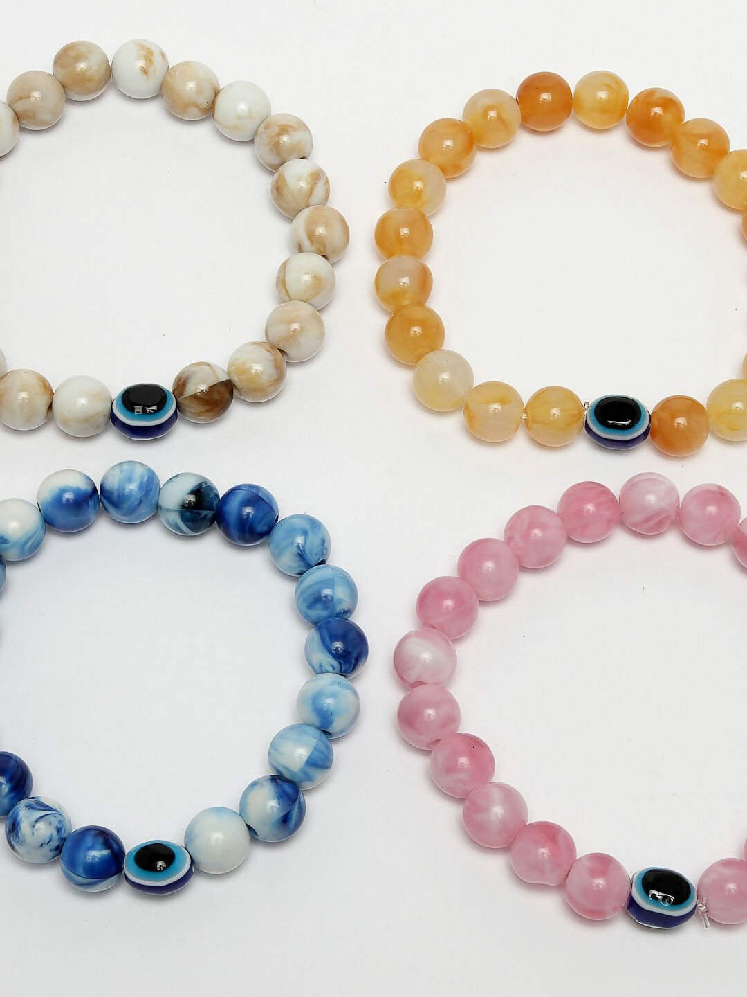 NVR Women & Men Set of 4 Multicolor Evil Eye Elasticated Rakhi With Roli Chawal | Grocsy