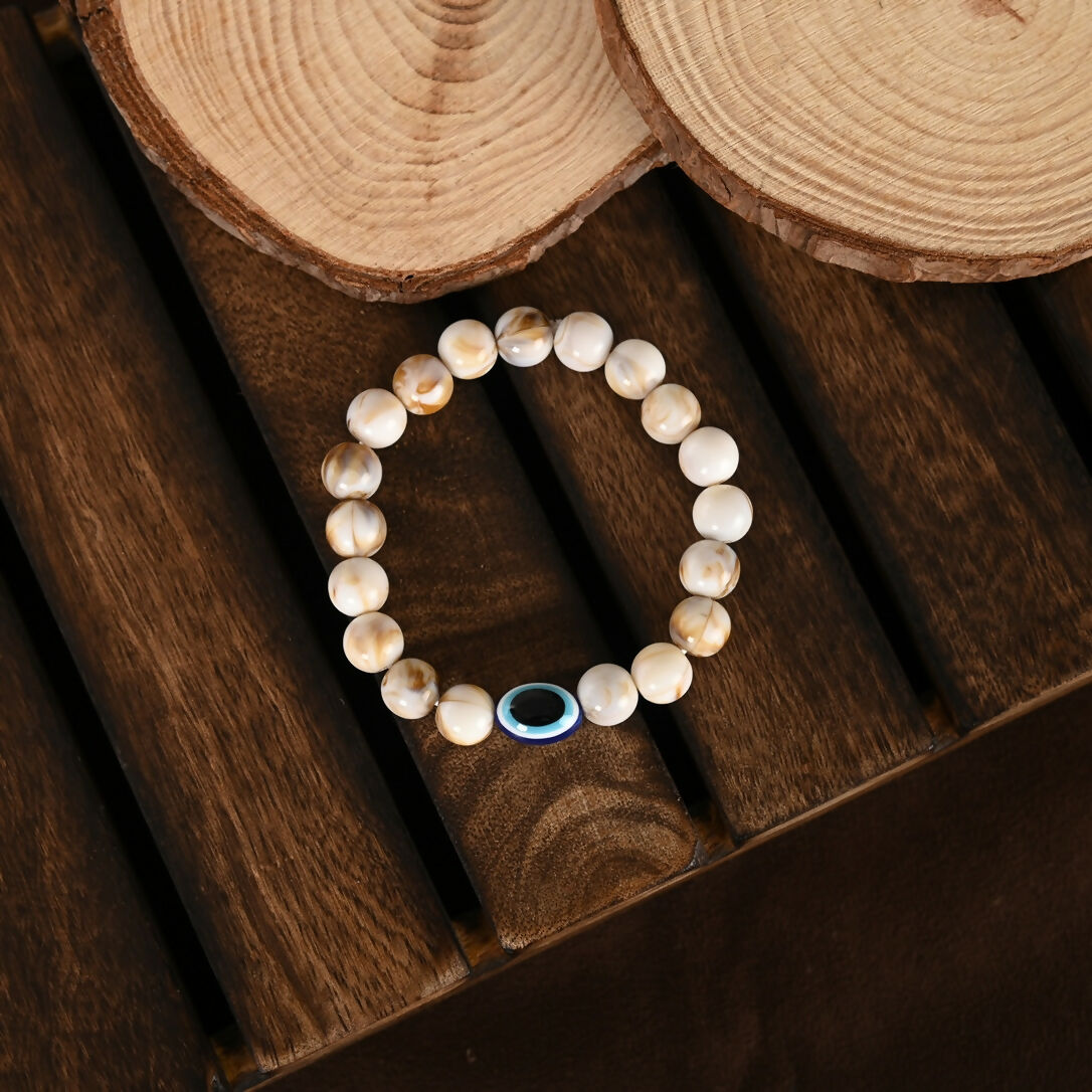 NVR Women & Men Cream-colored Evil Eye Elasticated Rakhi With Roli Chawal | Grocsy