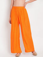 TAG 7 Women Orange Solid Flared Palazzos | Grocsy
