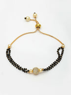NVR Women Gold-Polished & Black Brass AD-Studded Hand Mangalsutra Bracelet | Grocsy