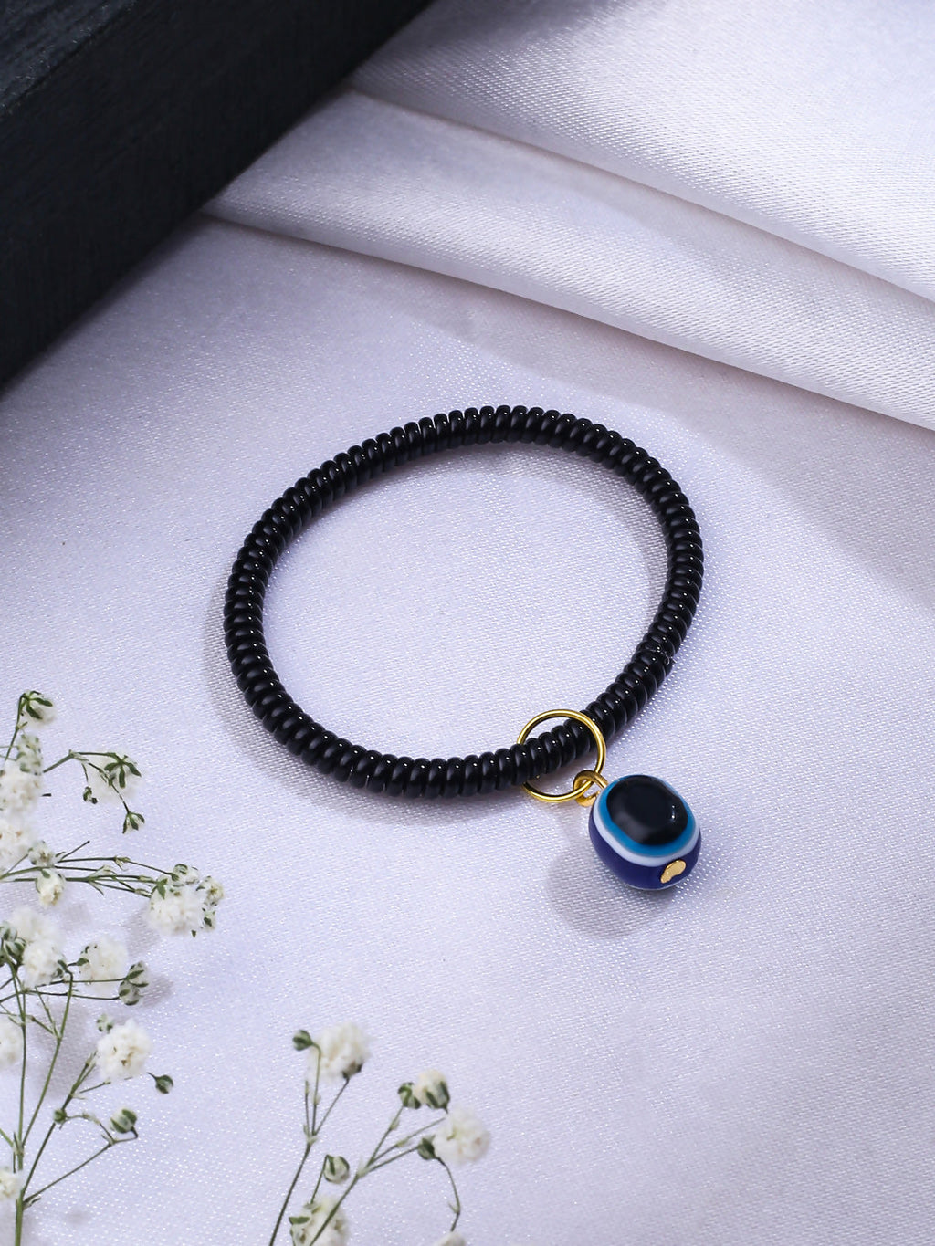 NVR Women & Men Black Evil Eye Spring Ring Rakhi With Roli Chawal | Grocsy