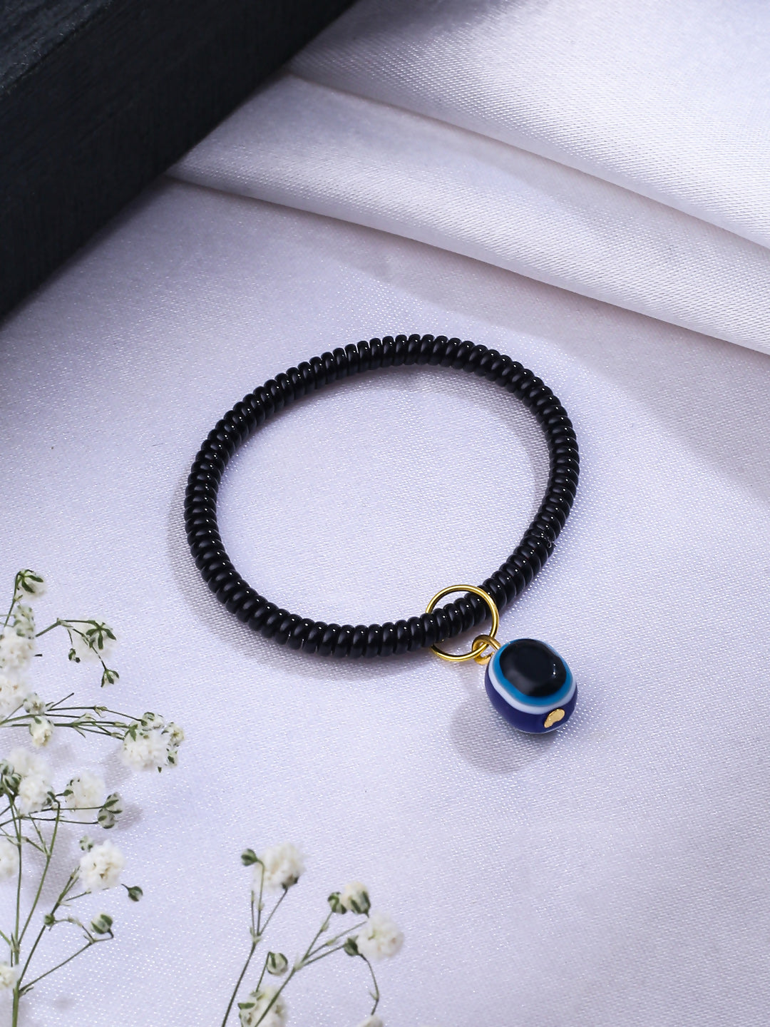 NVR Women & Men Black Evil Eye Spring Ring Rakhi With Roli Chawal | Grocsy