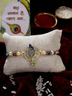 NVR Men Gold-Toned Peacock Design Stone-Studdded Rakhi With Roli Chawal | Grocsy