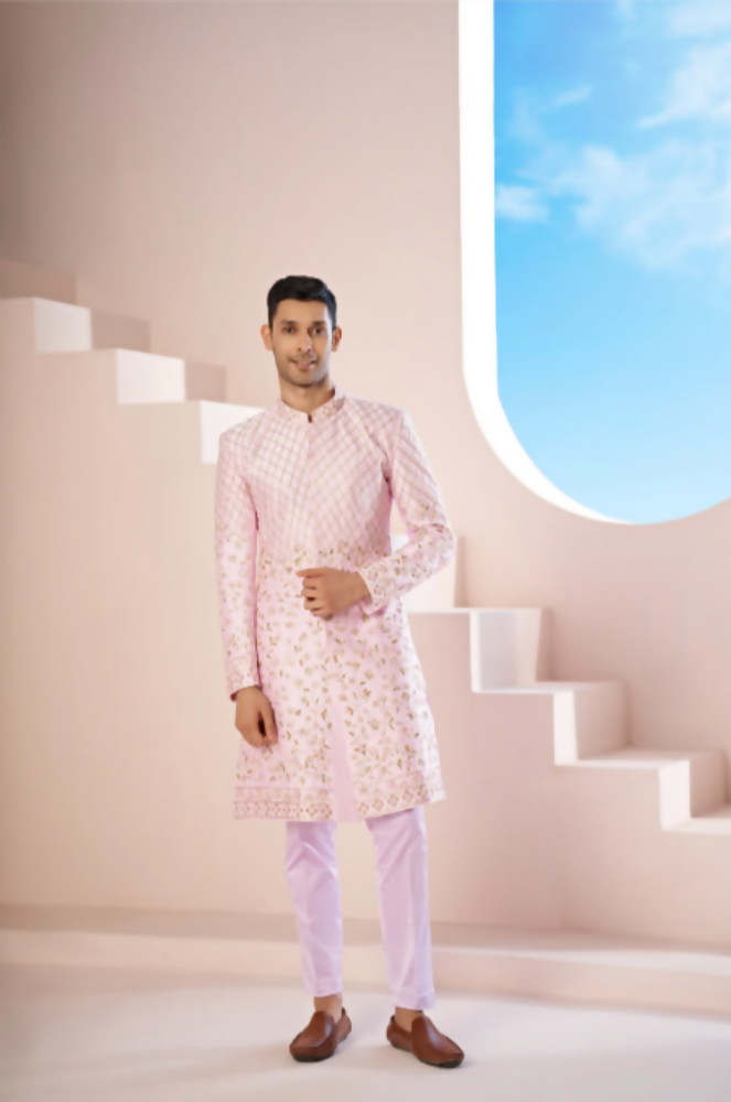A Pink Sherwani Featuring Elegant Cross-Line Patterns Adorned With Intricate Floral Designs by Hilo Design | Grocsy