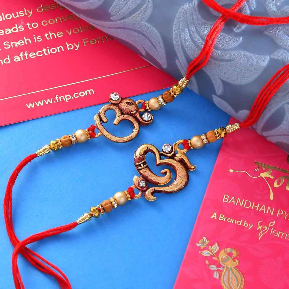 2 Divine Om Rakhis & Pista Kaju Roll Box Hamper Combo | Grocsy